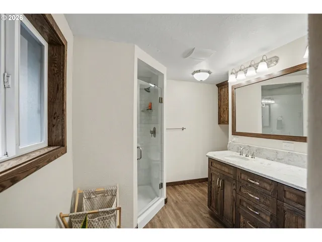a bathroom with a sink vanity and a mirror