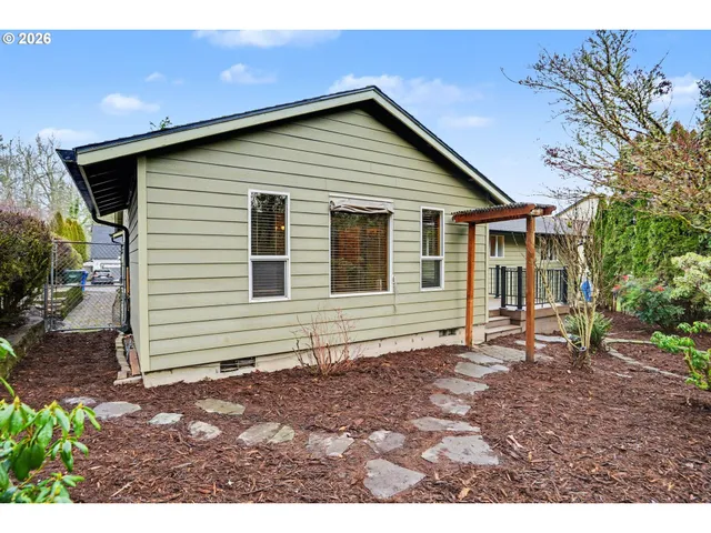 a front view of a house with a garden