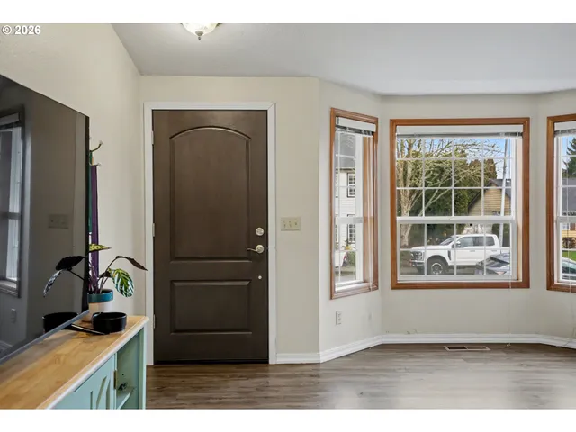 a view of front door with wooden floor