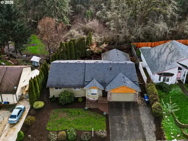 an aerial view of a house with a big yard and large trees