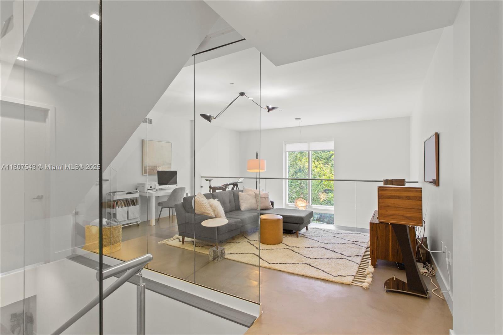 455 Northeast 39th Street, Unit 102 Miami, FL 33137 - Photo 12 of 32 a living room with furniture a window and a table