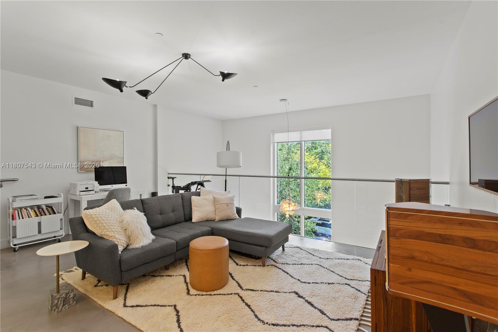 455 Northeast 39th Street, Unit 102 Miami, FL 33137 - Photo 13 of 32 a living room with furniture and a window