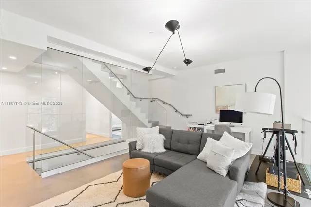 a living room with furniture and a floor to ceiling window