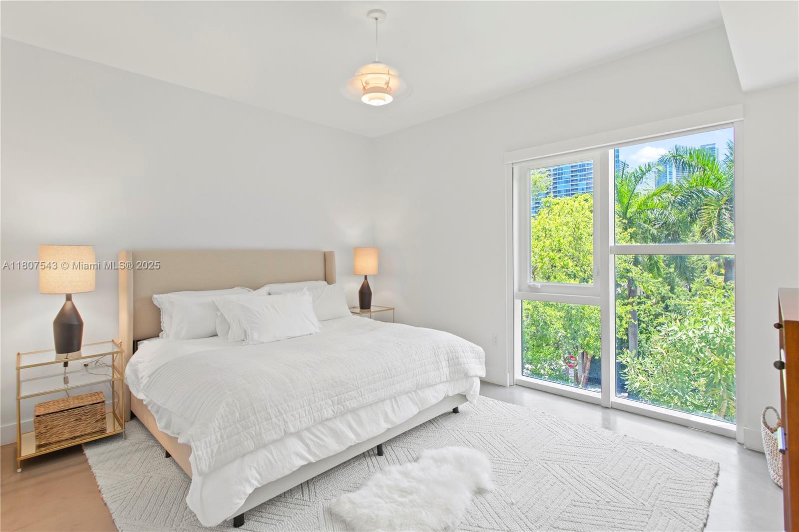 455 Northeast 39th Street, Unit 102 Miami, FL 33137 - Photo 16 of 32 a bedroom with a bed and a large window