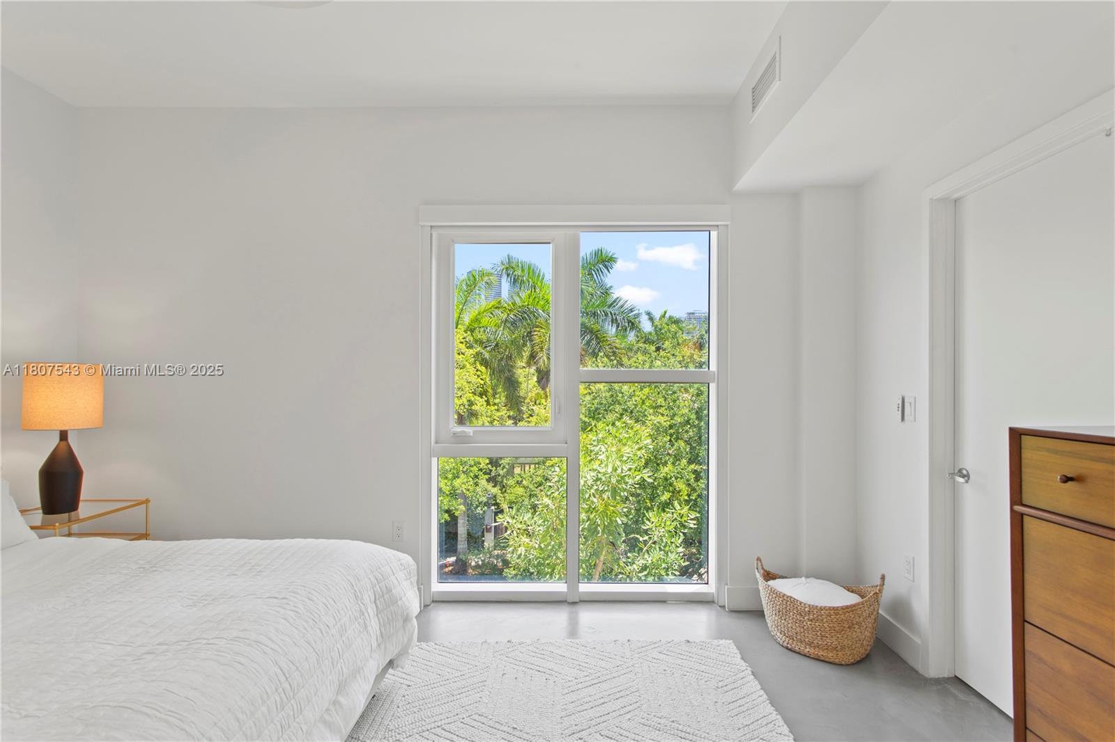455 Northeast 39th Street, Unit 102 Miami, FL 33137 - Photo 17 of 32 a bedroom with a bed and a window