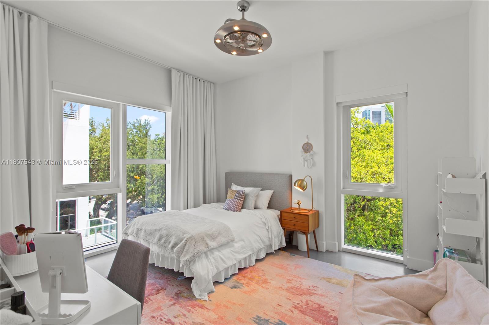 455 Northeast 39th Street, Unit 102 Miami, FL 33137 - Photo 20 of 32 a bedroom with a bed and a chandelier