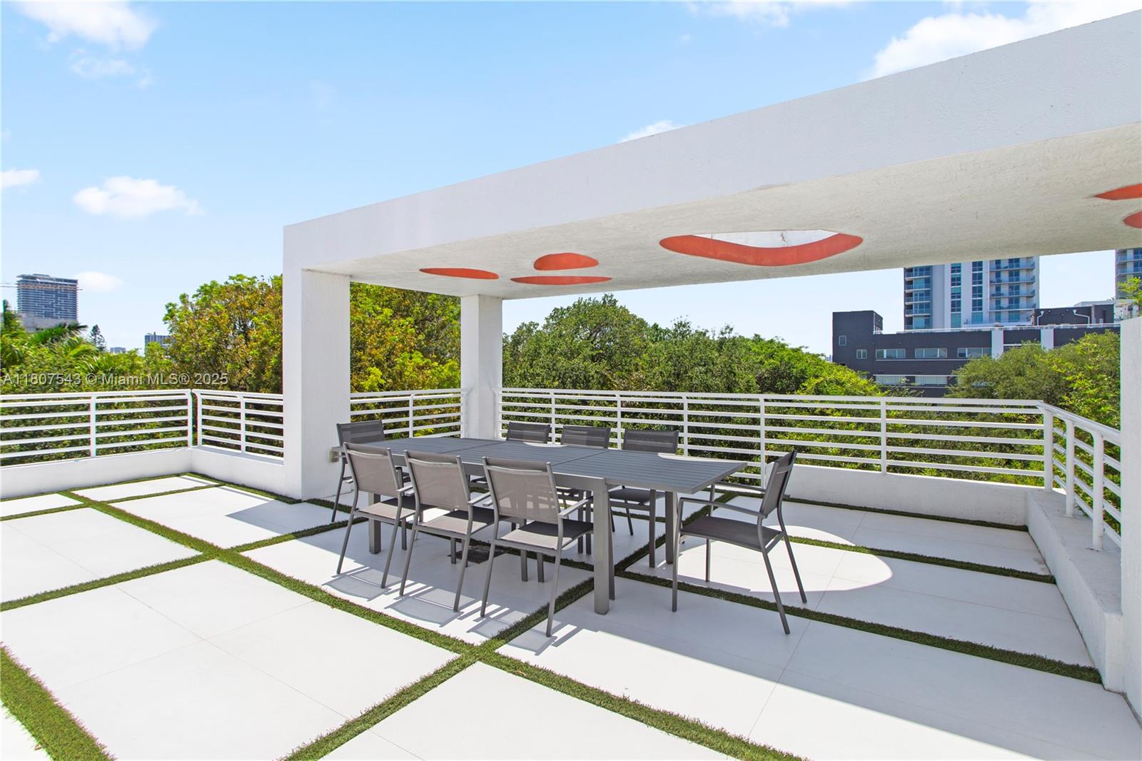 455 Northeast 39th Street, Unit 102 Miami, FL 33137 - Photo 22 of 32 a view of a chairs and tables in the roof deck