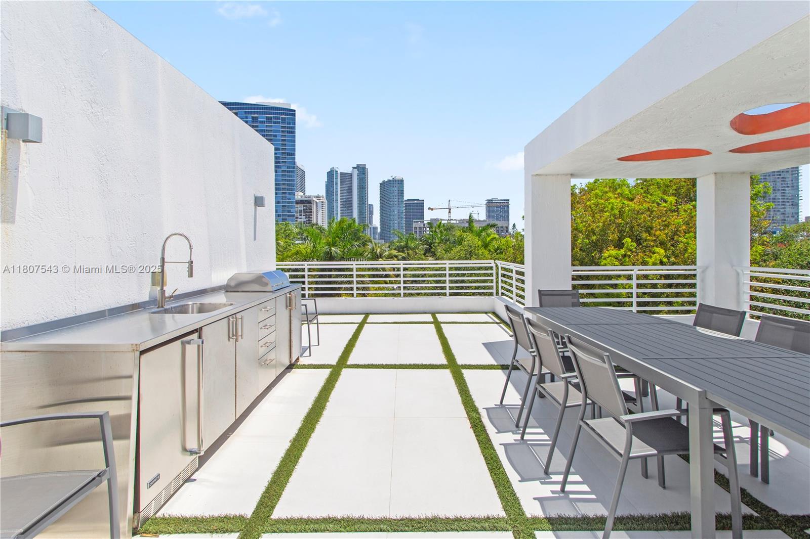 455 Northeast 39th Street, Unit 102 Miami, FL 33137 - Photo 23 of 32 a view of balcony with a floor to ceiling window and wooden floor