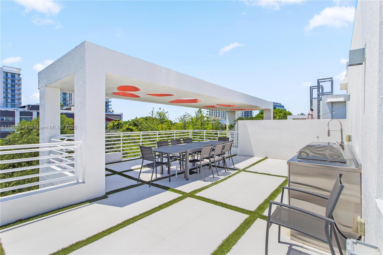 455 Northeast 39th Street, Unit 102 Miami, FL 33137 - Photo 24 of 32 a view of a patio with table and chairs