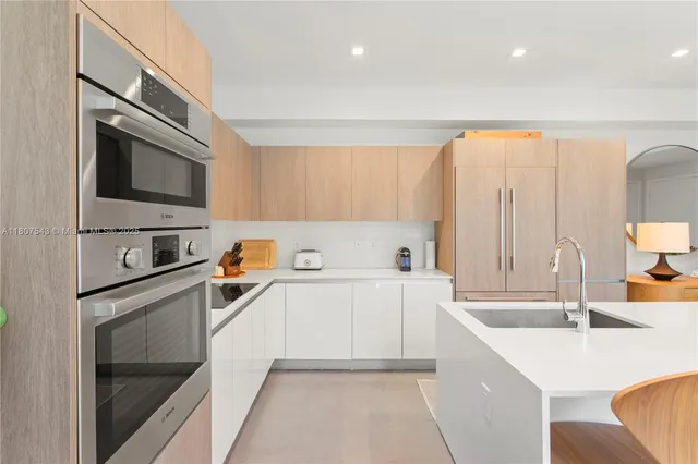 a kitchen with a sink stove and cabinets