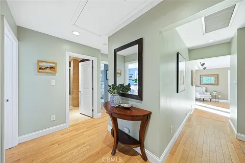 a view of a livingroom with wooden floor and furniture