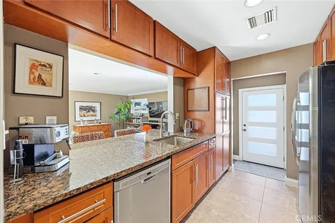 a kitchen with stainless steel appliances granite countertop a sink and cabinets