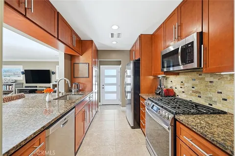 a kitchen with stainless steel appliances granite countertop a stove and a sink