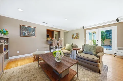 a living room with furniture and a table with wooden floor