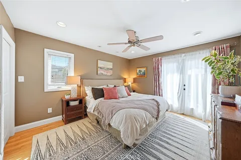 a bedroom with a large bed a chandelier and a window