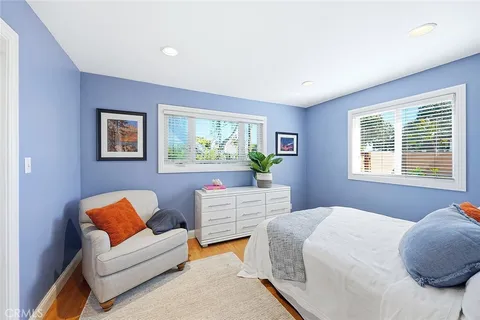 a bedroom with two beds and a couch