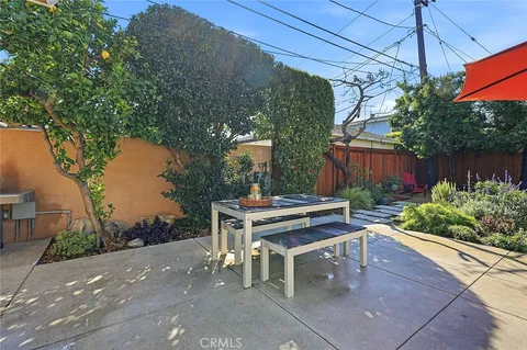 a view of a patio with a table and chairs under an umbrella
