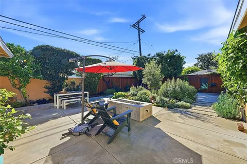 a view of a patio with a table and chairs under an umbrella