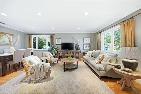 a living room with furniture large windows and a flat screen tv