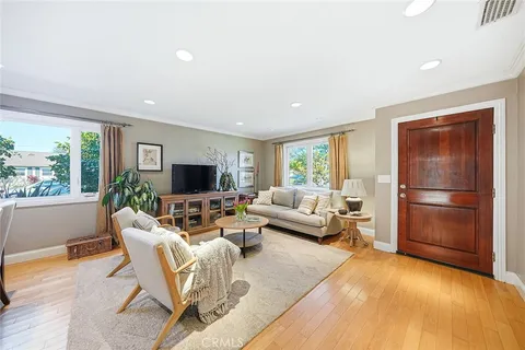 a living room with furniture wooden floor and a fireplace