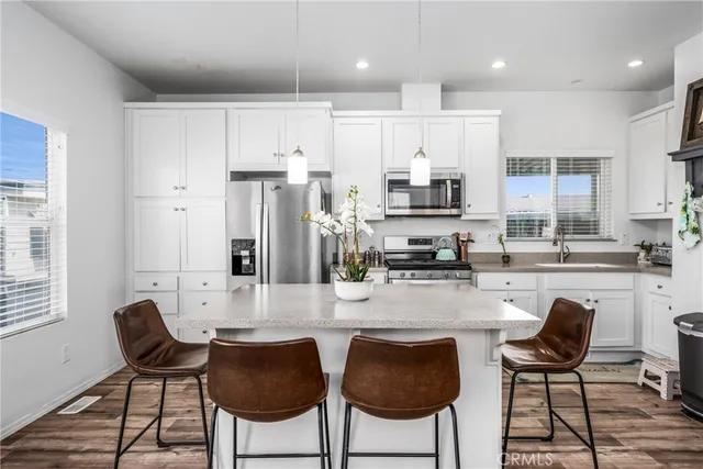 a kitchen with stainless steel appliances granite countertop a stove a microwave and cabinets