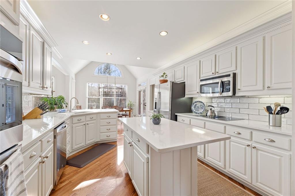 1476 Annapolis Way Grayson, GA 30017 - Photo 11 of 51 a kitchen with white cabinets sink and stainless steel appliances