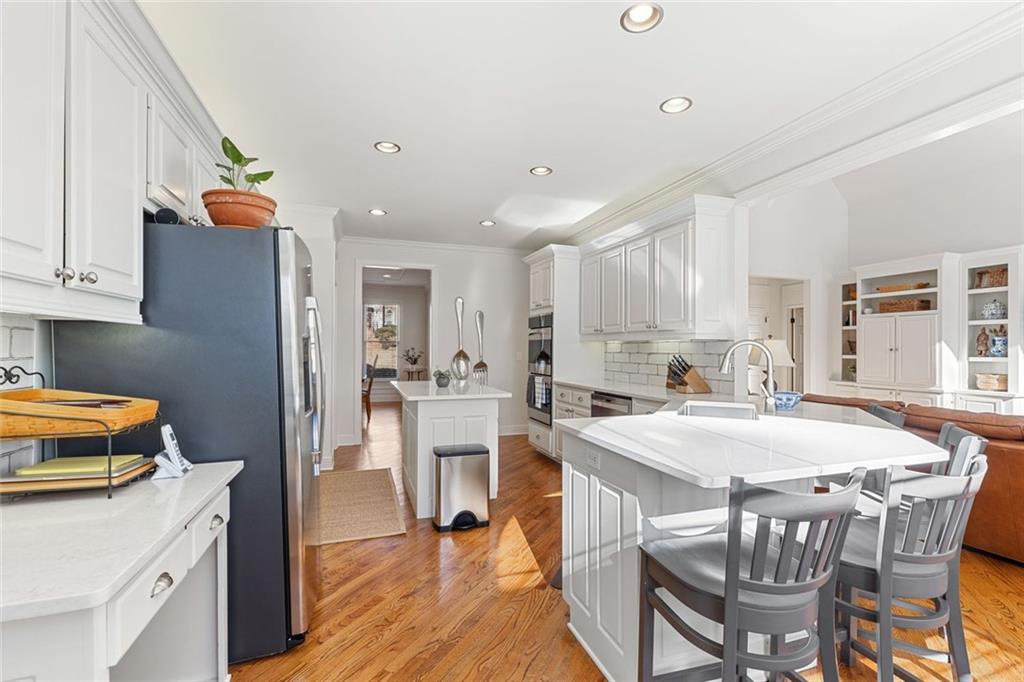 1476 Annapolis Way Grayson, GA 30017 - Photo 13 of 51 a kitchen that has a dining table chairs and refrigerator
