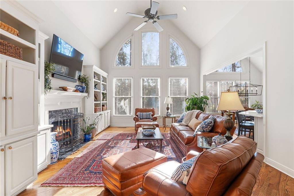 1476 Annapolis Way Grayson, GA 30017 - Photo 17 of 51 a living room with furniture a fireplace and a chandelier