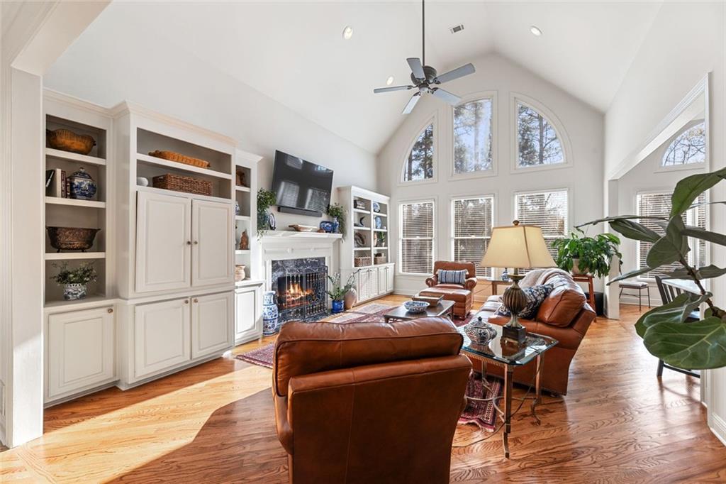1476 Annapolis Way Grayson, GA 30017 - Photo 18 of 51 a living room with furniture a fireplace and a chandelier