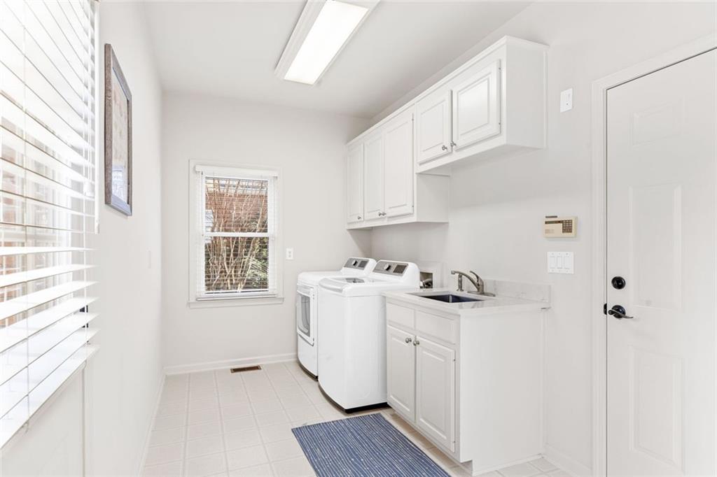 1476 Annapolis Way Grayson, GA 30017 - Photo 24 of 51 a kitchen with stainless steel appliances a stove a sink a refrigerator and cabinets