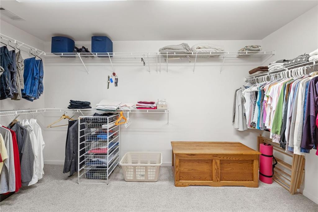 1476 Annapolis Way Grayson, GA 30017 - Photo 32 of 51 a view of walk in closet with clothes and shoes
