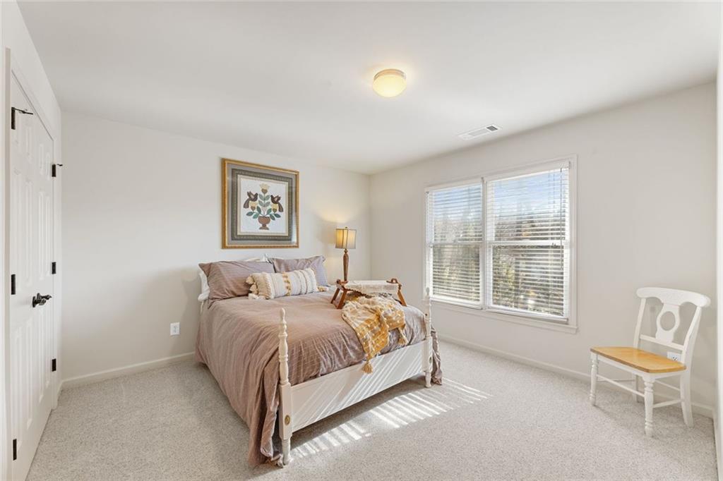 1476 Annapolis Way Grayson, GA 30017 - Photo 36 of 51 a bedroom with a bed and chair