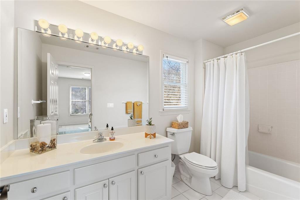1476 Annapolis Way Grayson, GA 30017 - Photo 38 of 51 a bathroom with a toilet a sink a tub and mirror