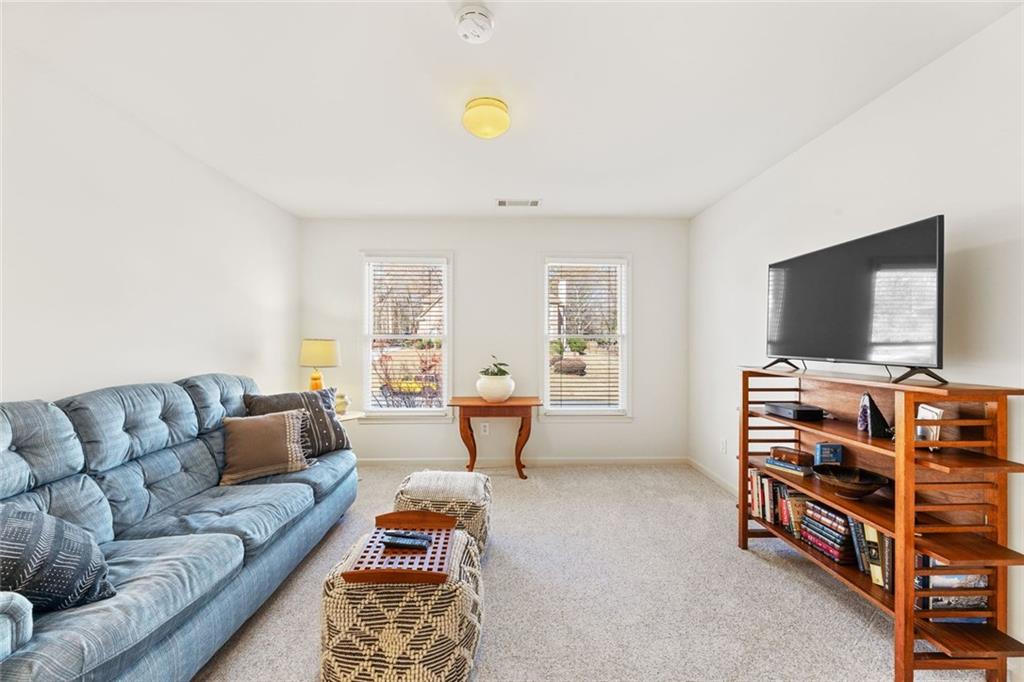 1476 Annapolis Way Grayson, GA 30017 - Photo 39 of 51 a living room with furniture and a flat screen tv