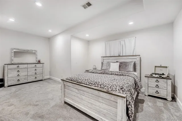 a bedroom with a bed and a couch