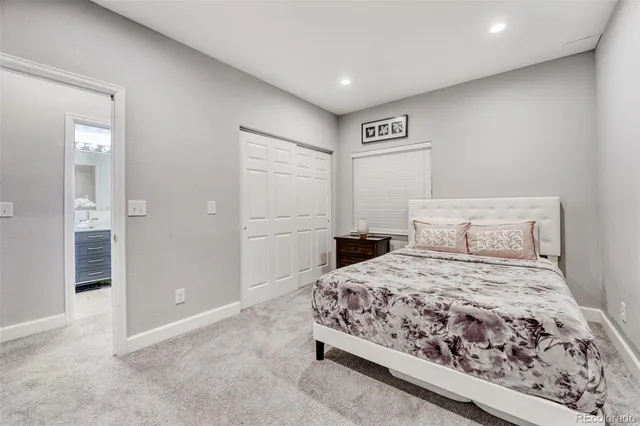 a bedroom with a bed and painting on the wall