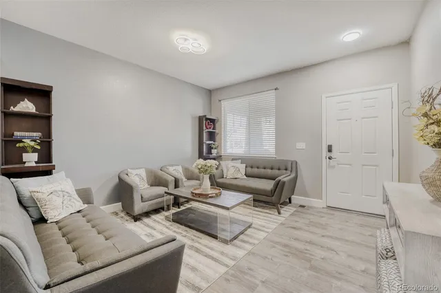 a living room with furniture and a potted plant