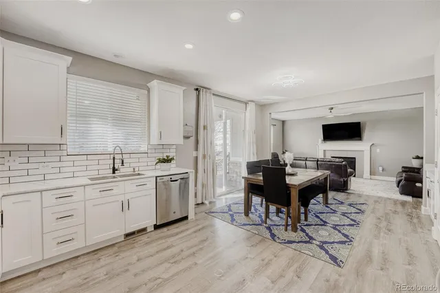 a view of a kitchen area with furniture and wooden floor