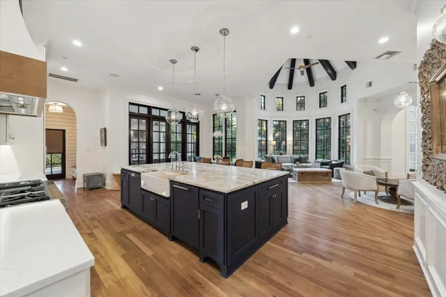 a kitchen with stainless steel appliances granite countertop a stove and a large refrigerator