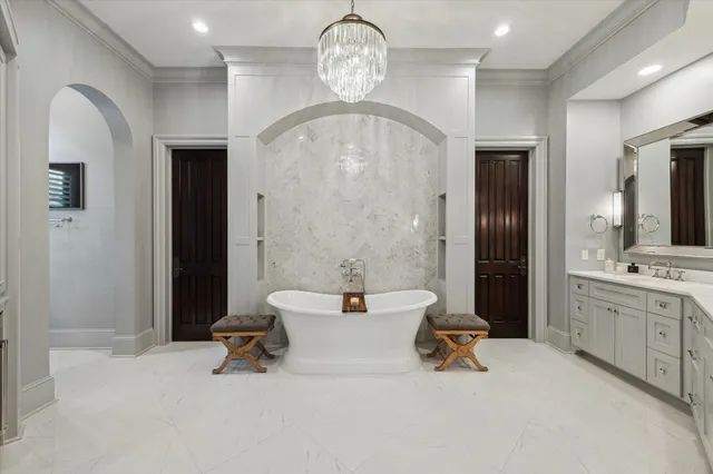 a spacious bathroom with a double vanity sink a mirror and a bathtub