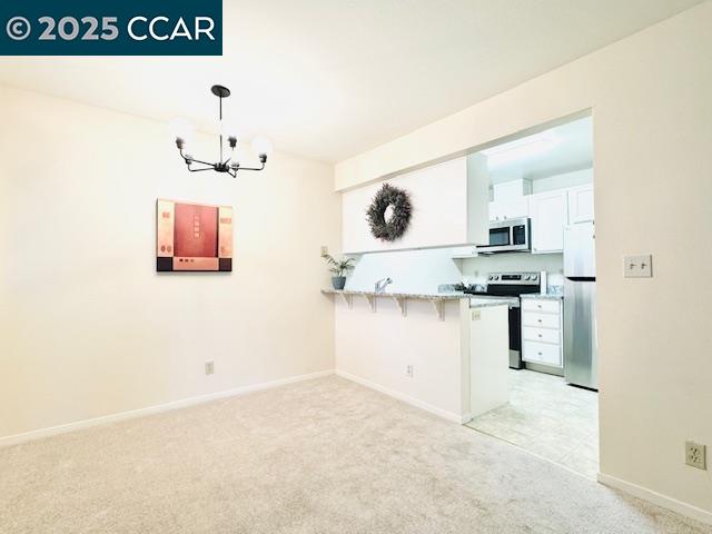 5425 Concord Boulevard, Unit F4 Concord, CA 94521 - Photo 6 of 17 a kitchen with cabinets and wooden floor