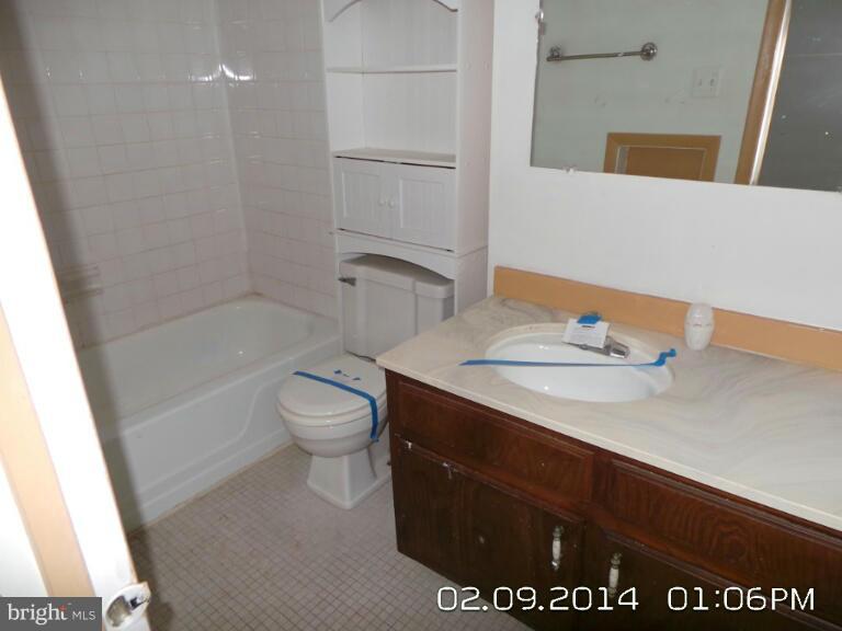 5253 West Running Brook Road, Unit 201 Columbia, MD 21044 - Photo 8 of 9 a bathroom with a sink a toilet and shower