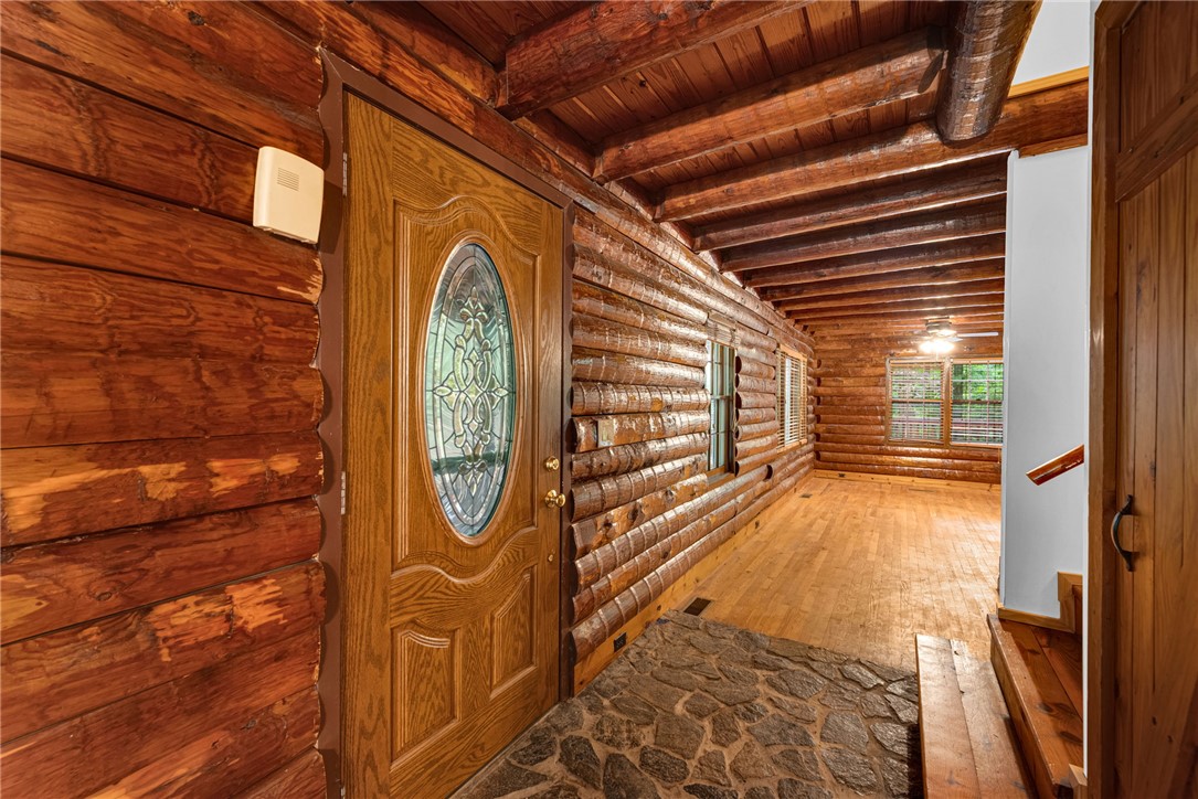 237 Spring Valley Road Liberty, SC 29657 - Photo 2 of 50 Solid log construction creates a rustic entry, complemented by the warmth of natural wood flooring and a stone entry.