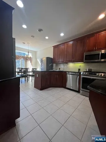 a large kitchen with lots of counter and chairs
