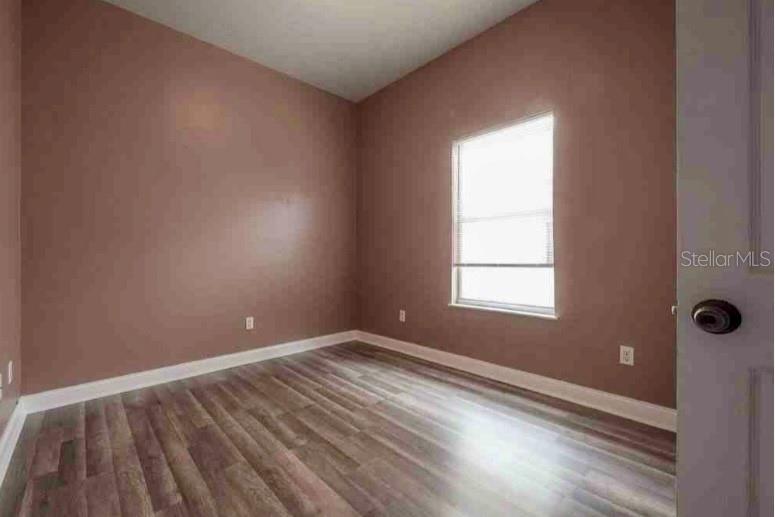 2322 West Cherry Street Tampa, FL 33607 - Photo 11 of 31 an empty room with wooden floor and windows