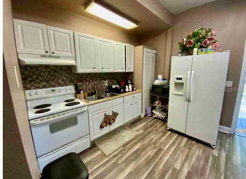 2322 West Cherry Street Tampa, FL 33607 - Photo 16 of 31 a kitchen with stainless steel appliances a refrigerator sink and cabinets