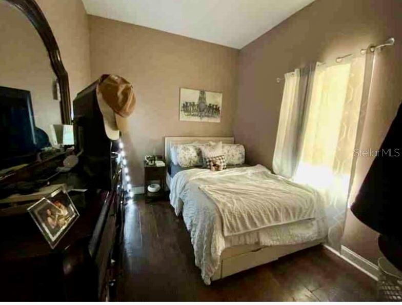 2322 West Cherry Street Tampa, FL 33607 - Photo 18 of 31 a bedroom with a bed and a flat tv screen on the dresser