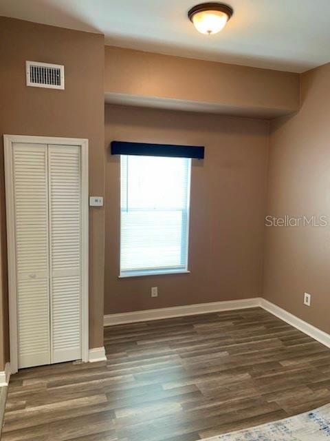 2322 West Cherry Street Tampa, FL 33607 - Photo 25 of 31 an empty room with wooden floor and windows