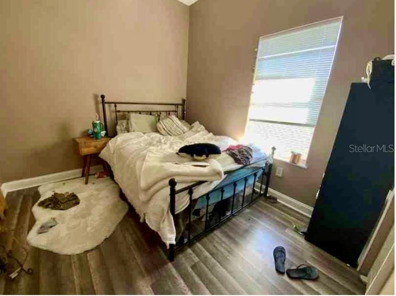 2322 West Cherry Street Tampa, FL 33607 - Photo 29 of 31 a bedroom with a bed and wooden floor
