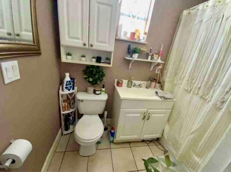2322 West Cherry Street Tampa, FL 33607 - Photo 30 of 31 a bathroom with a sink a toilet and a mirror